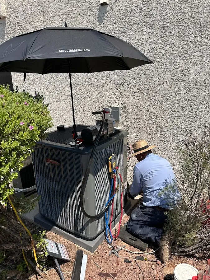 HVAC technician performing outdoor AC maintenance in Maidencreek